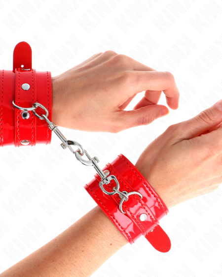 Algemas de pulso KINK vermelhas com tachas, ajustáveis entre 23 e 33 cm.